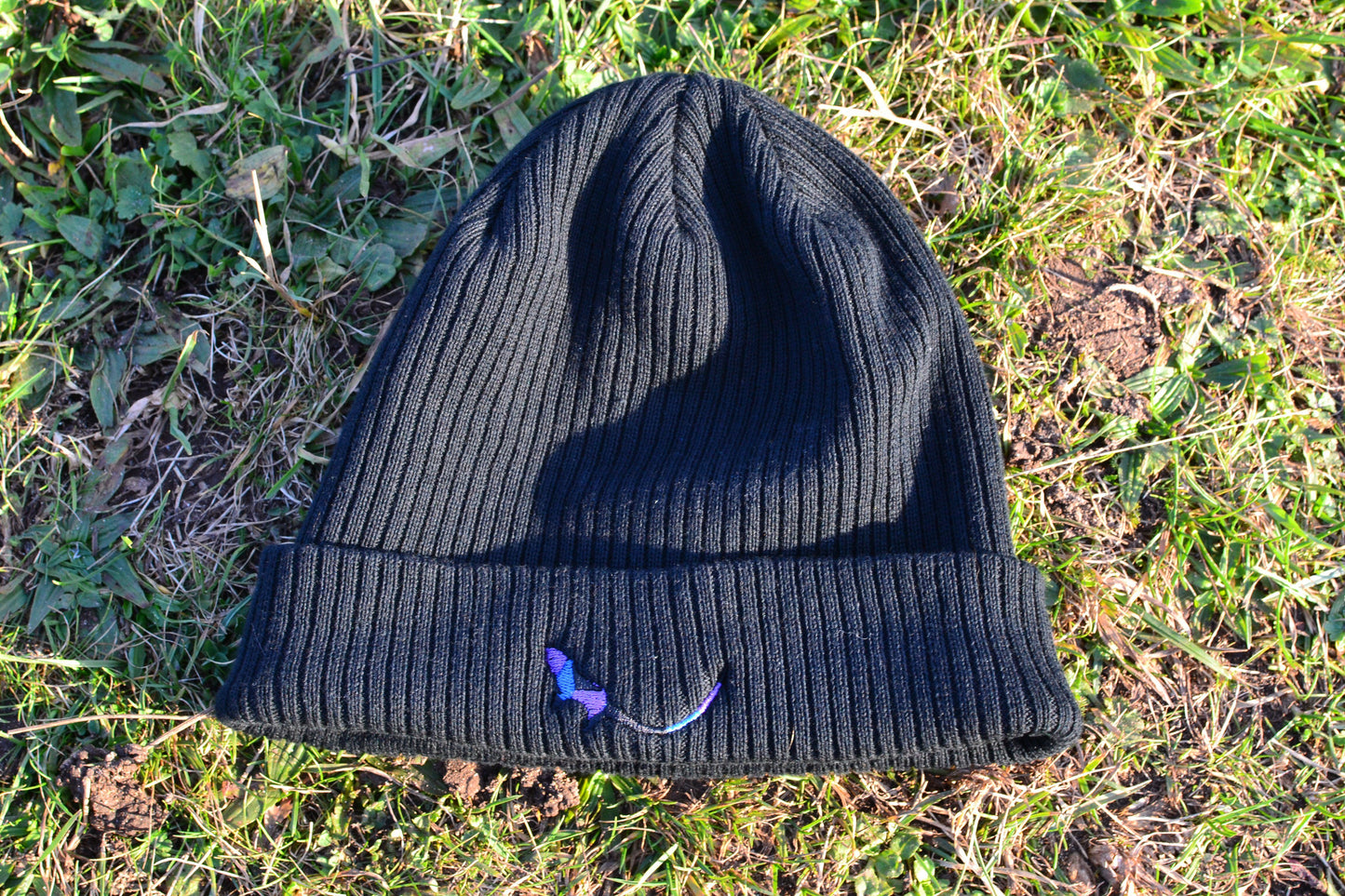 Black Organic Eco-Beanie sitting on grass