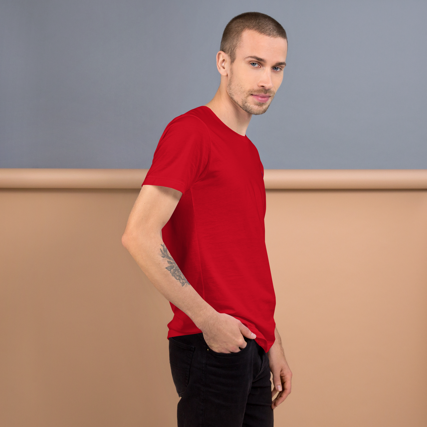 Model wearing THE SUBTROPIC Global Tee in vibrant red, showcasing versatile style and global appeal.