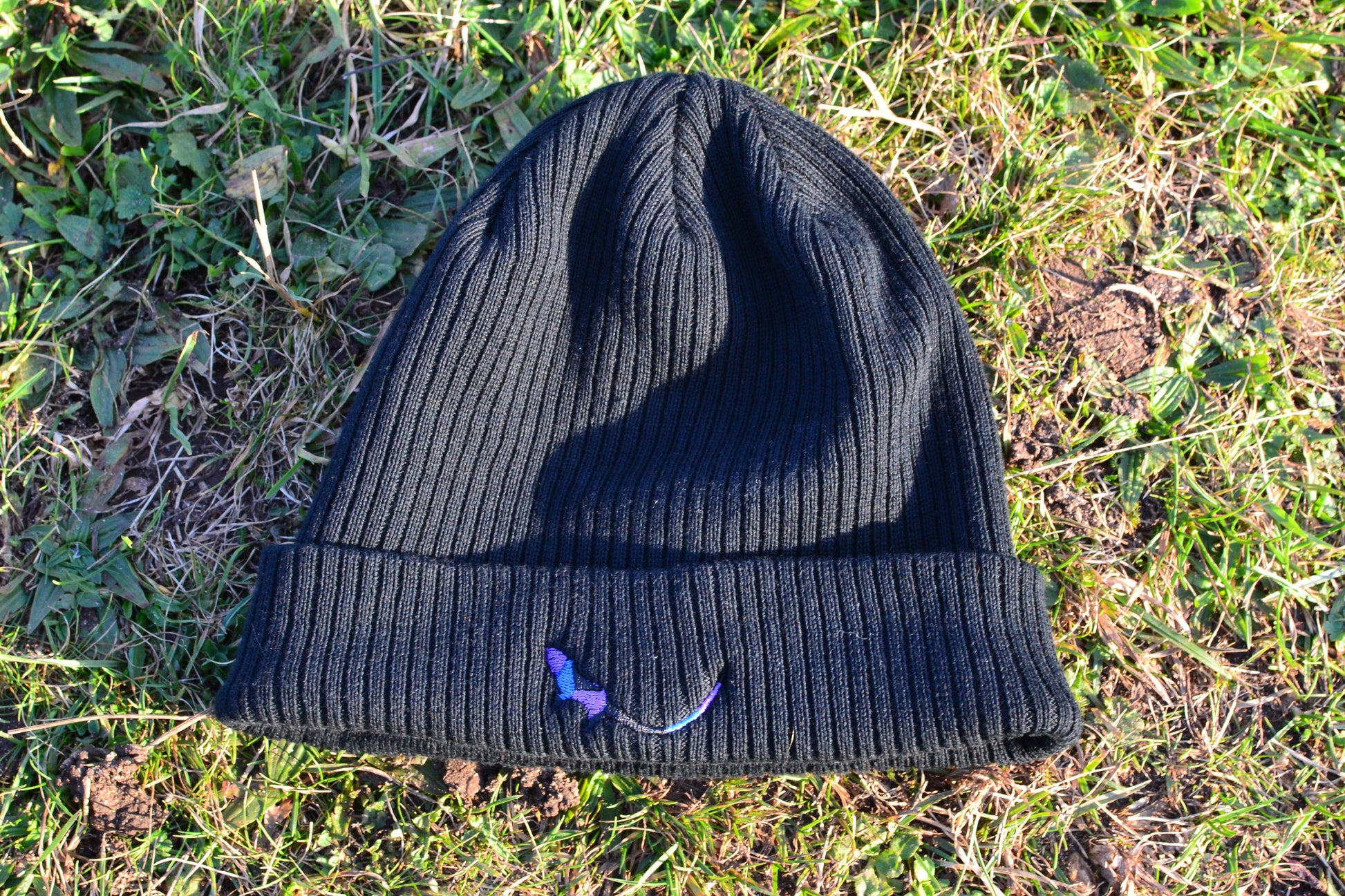 Black Organic Eco-Beanie sitting on grass