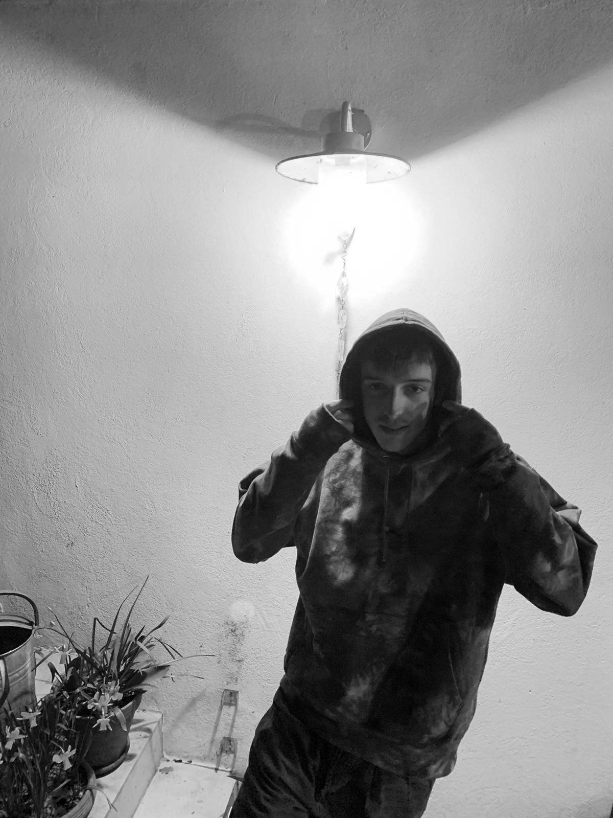 SUBTROPIC X Champion Tie-Dye Black Hoodie worn by model 1